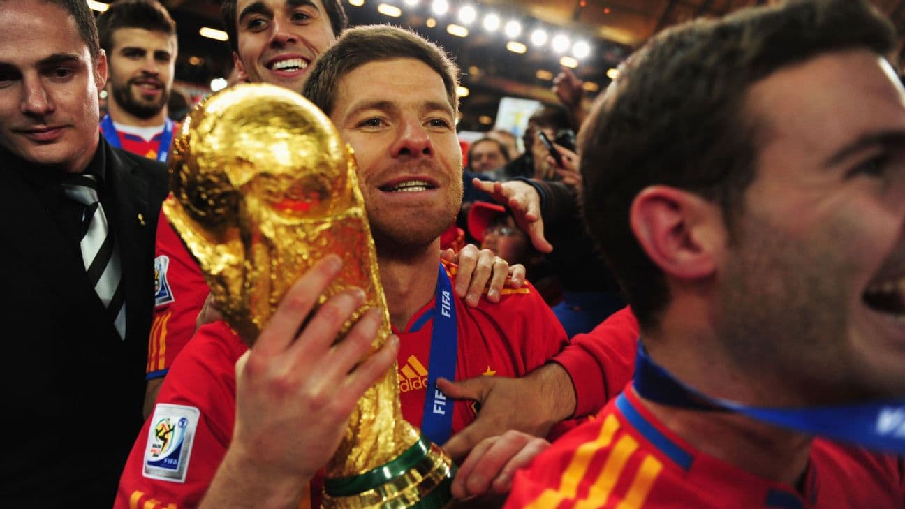 Xabi Alonso celebrates Spain's 2010 World Cup win with the trophy