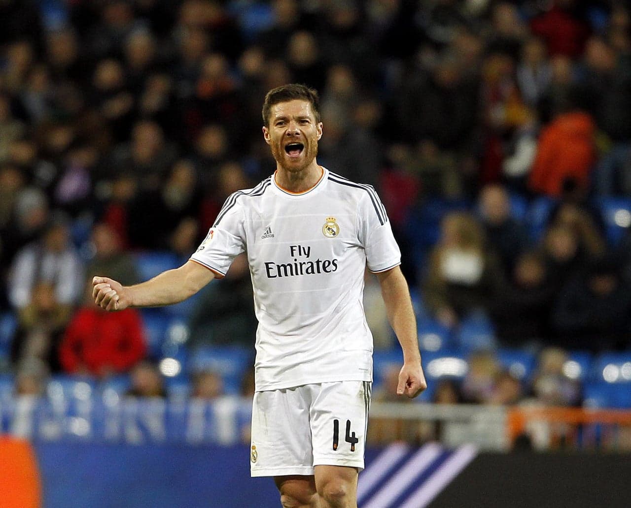 Xabi Alonso celebrates in Real Madrid's white number 14 shirt