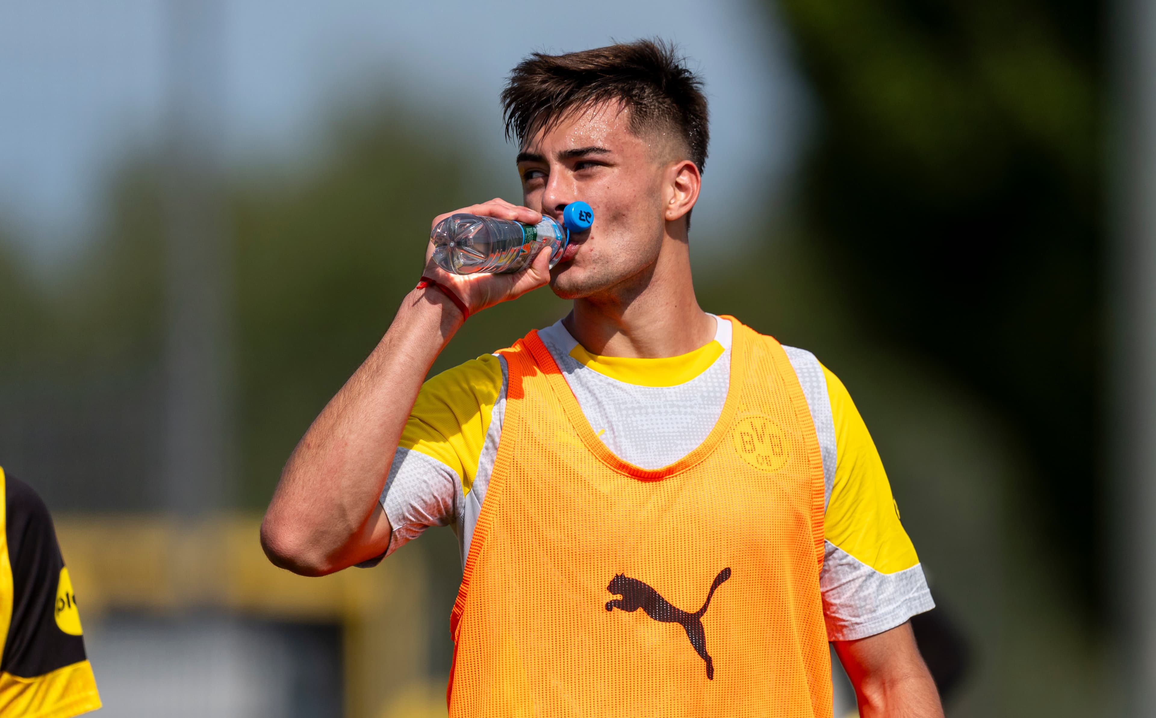 Aarón Anselmino takes a drinks break during Borussia Dortmund training